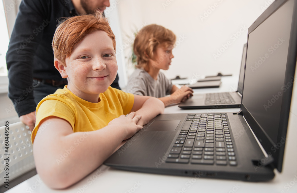 Mother and son using laptop on bed Mother and son using laptop on bed
