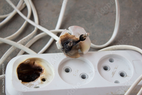 Fotografie the plug and socket burned melted short circuit