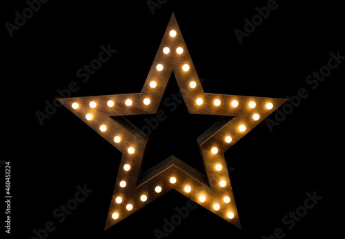 Wooden star with lights on black background