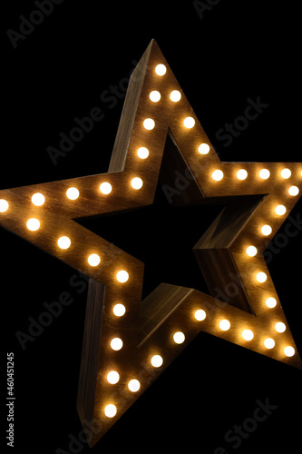 Wooden star with lights on black background