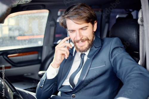 businessmen in a suit in a car a trip to work communication by phone © SHOTPRIME STUDIO