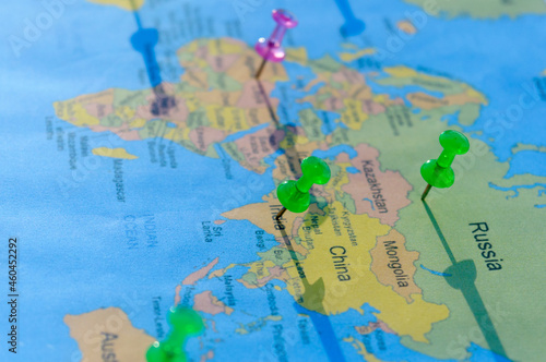 Location Pin on a World Map. Global Mapping. Close up. Table Top View. Selective focus. Shallow depth of field.