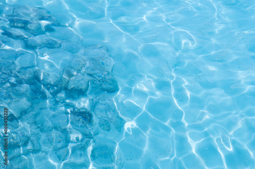 Water background, turquoise shallow sea water. Beautiful texture of sun glare on the water. Water background, turquoise shallow sea water. Beautiful texture of sun glare on the water.