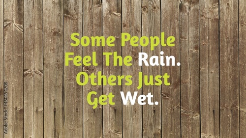 Inspirational and motivational Life quotes with Blur wooden Background- Some people feel the rain. Others just get wet.