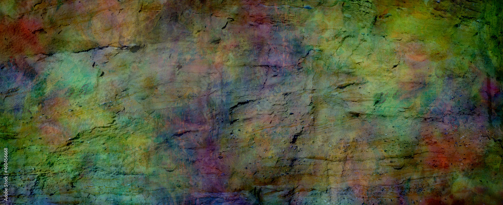 Multicoloured grunge rock face banner background - textured rough earthy richly deeply coloured wide banner ideal for a grunge background
