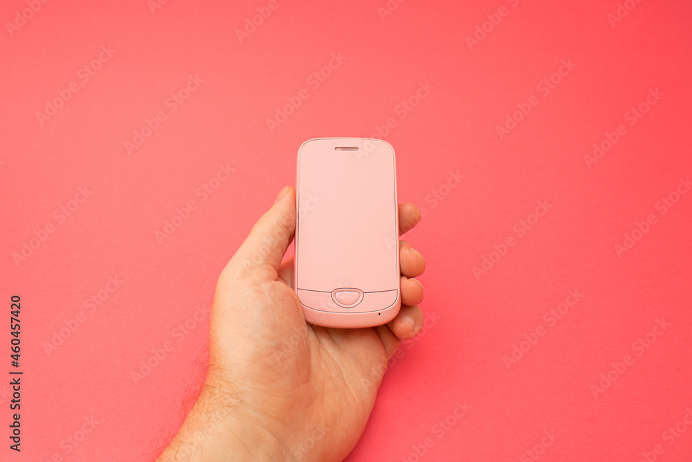 Hand holding pink 3d smartphone against red background. 3D illustration design template background. Top mobile phone message. Advertisement idea. Empty copy space for ad Hand holding pink 3d smartphone against red background. 3D illustration design template background. Top mobile phone message. Advertisement idea. Empty copy space for ad
