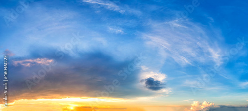 Sky at sunset blue and orange light of the sun through the clouds in the sky