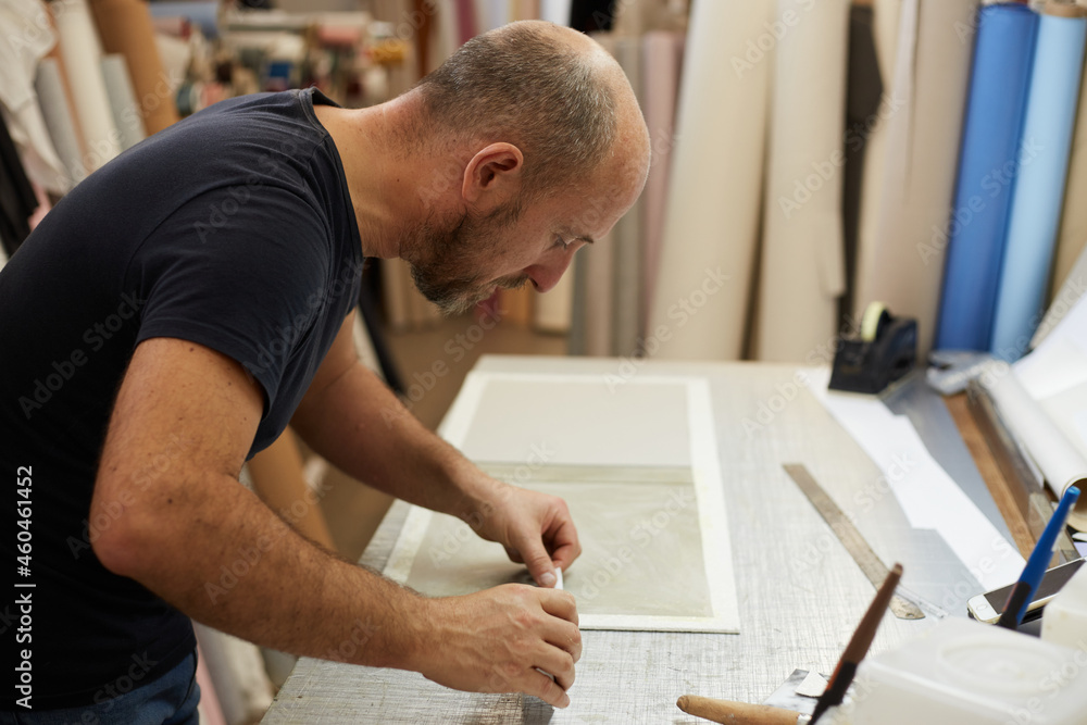 book binder working in a workshop book binder working in a workshop