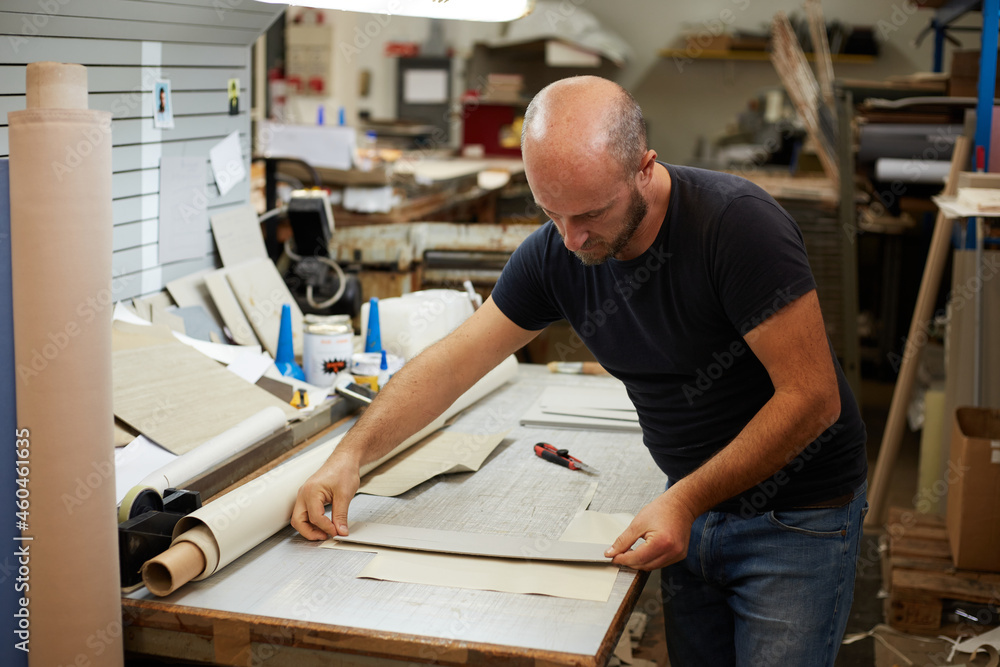 book binder working in a workshop book binder working in a workshop