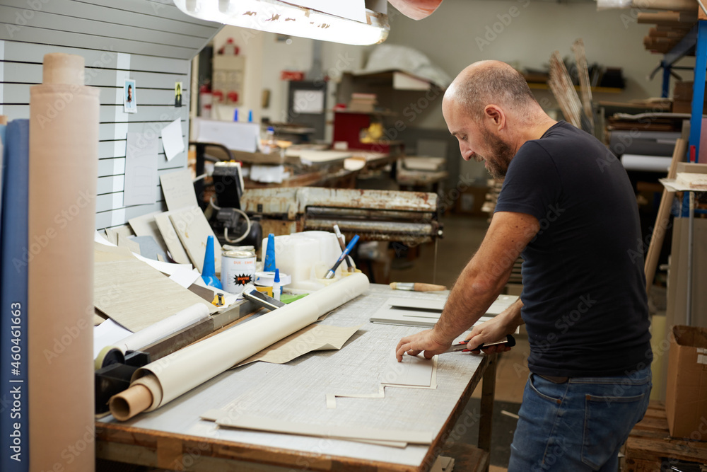 book binder working in a workshop book binder working in a workshop