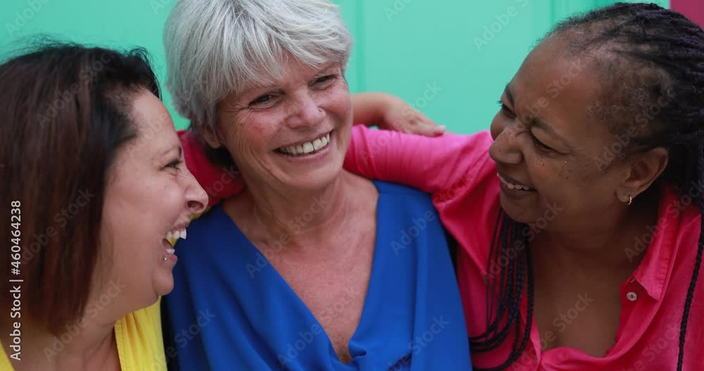 Happy senior multiracial women hugging each others - Elderly female friendship concept Happy senior multiracial women hugging each others - Elderly female friendship concept