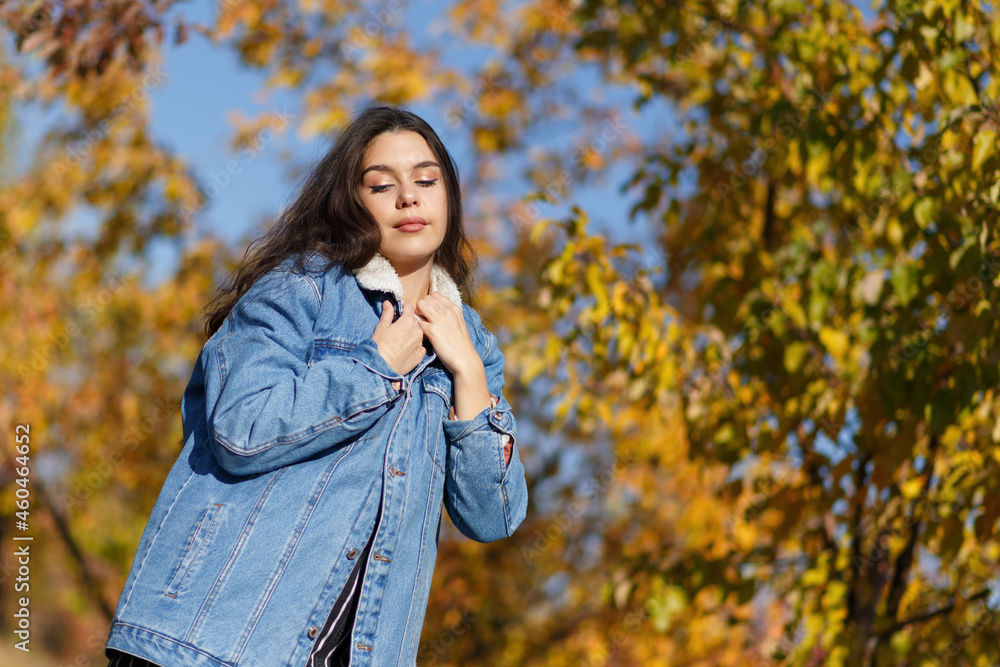 Portrait of young woman walking outdoors in autumn park Portrait of young woman walking outdoors in autumn park