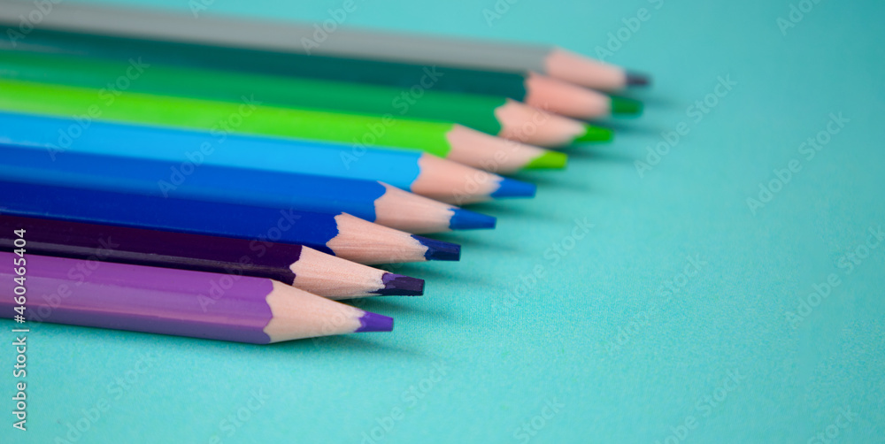 Colored pencils on a blue background Colored pencils on a blue background