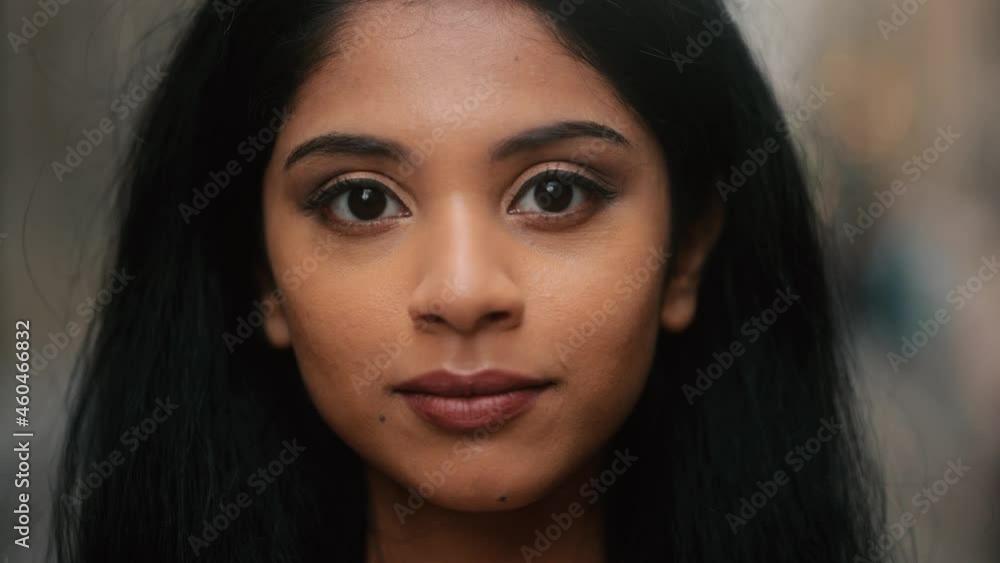 Portrait of attractive Indian girl looking at the camera. Young girl with long hair at the city street. . High quality 4k footage Portrait of attractive Indian girl looking at the camera. Young girl with long hair at the city street. . High quality 4k footage