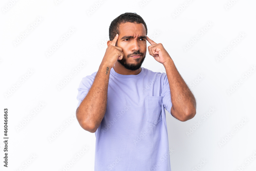 Fototapeta premium Young Ecuadorian man isolated on white background having doubts and thinking
