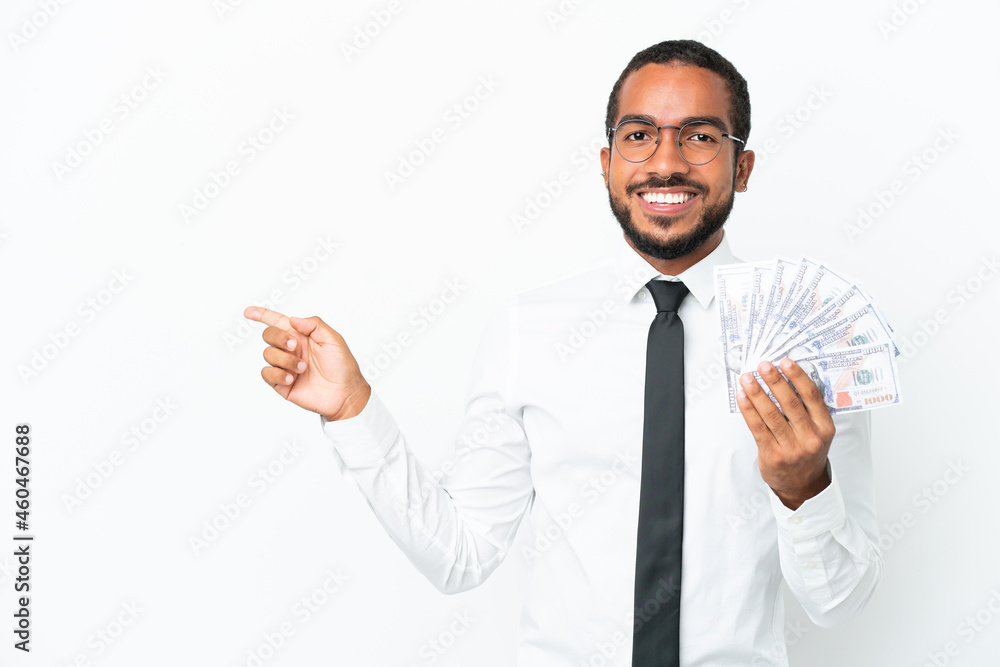 Young business latin man taking a lot of money isolated on white background pointing finger to the side Young business latin man taking a lot of money isolated on white background pointing finger to the side