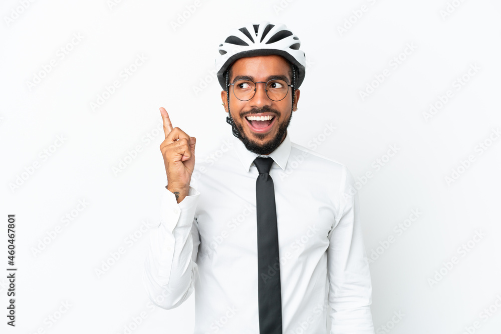 Young business latin man holding a bike helmet isolated on white background intending to realizes the solution while lifting a finger up Young business latin man holding a bike helmet isolated on white background intending to realizes the solution while lifting a finger up