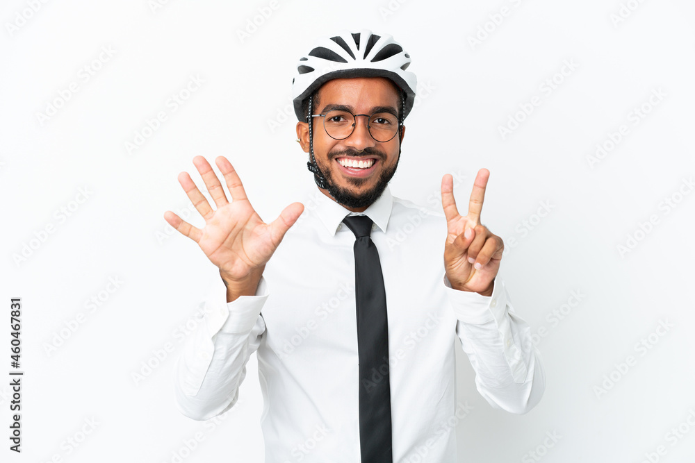 Young business latin man holding a bike helmet isolated on white background counting seven with fingers Young business latin man holding a bike helmet isolated on white background counting seven with fingers