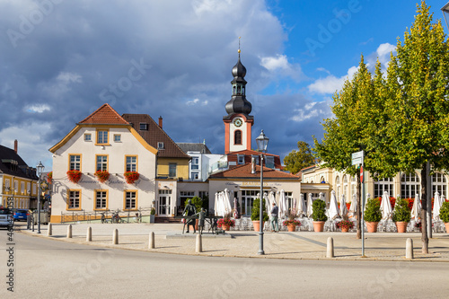 Schwetzingen, Germany. View of Schlossplatz (near the castle square) with the monument to the asparagus merchant and the bell tower of the Kirche St. Pankratius church