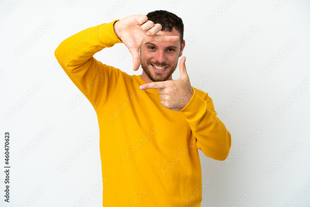 Young Brazilian man isolated on white background focusing face. Framing symbol Young Brazilian man isolated on white background focusing face. Framing symbol