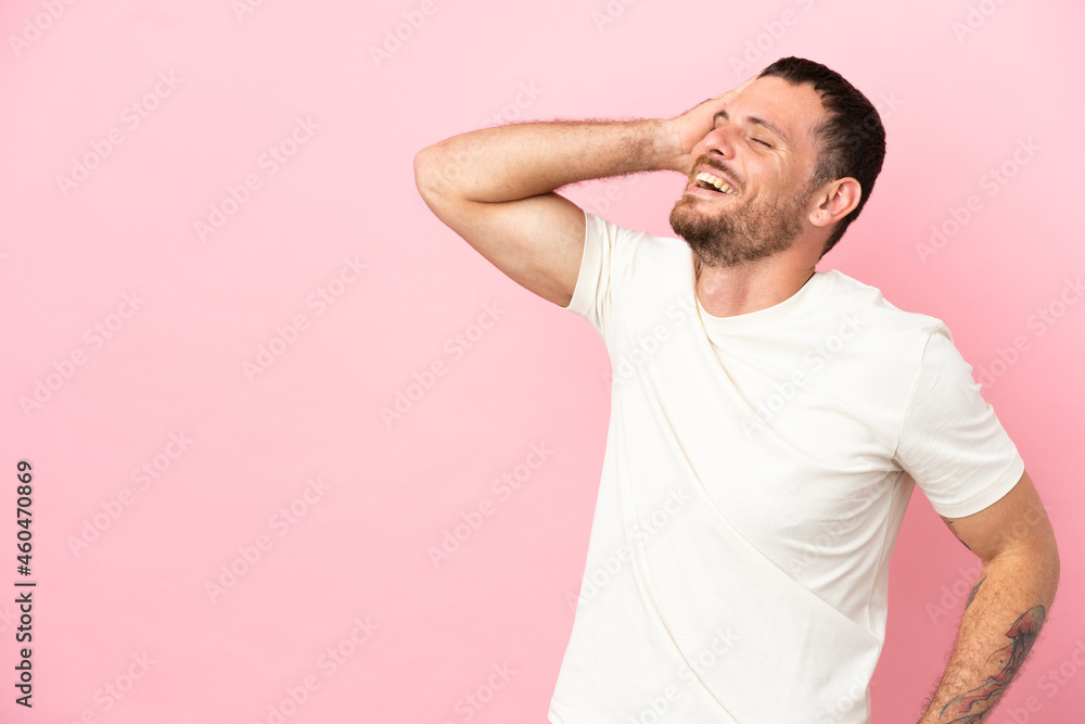 Young Brazilian man isolated on pink background smiling a lot Young Brazilian man isolated on pink background smiling a lot