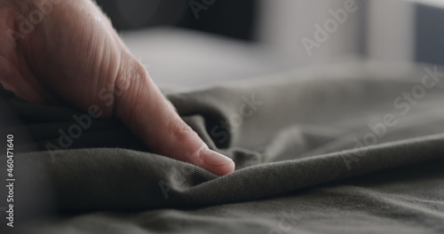 man touching green cotton clothes closeup © GCapture