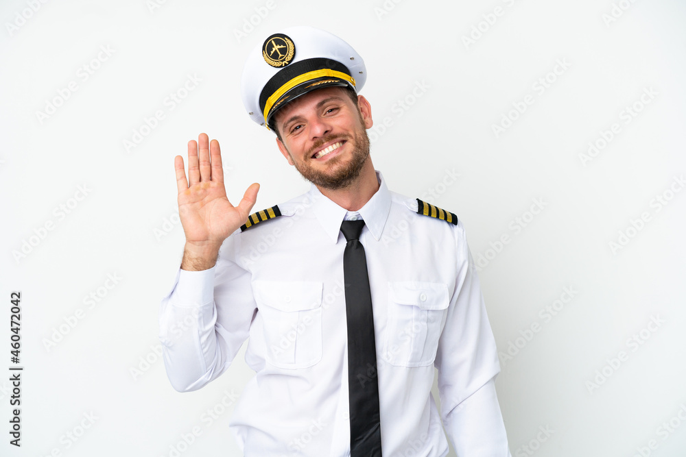 Airplane Brazilian pilot isolated on white background saluting with hand with happy expression Airplane Brazilian pilot isolated on white background saluting with hand with happy expression