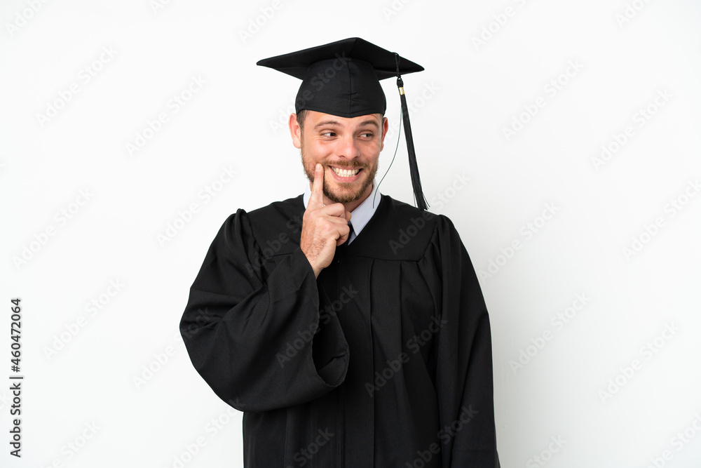 Young university Brazilian graduate isolated on white background thinking an idea while looking up Young university Brazilian graduate isolated on white background thinking an idea while looking up