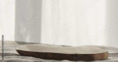 Empty olive wood board on linen cloth with copy space