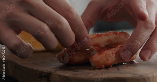 man serving crab with dip sauce and sliced sweed lemon