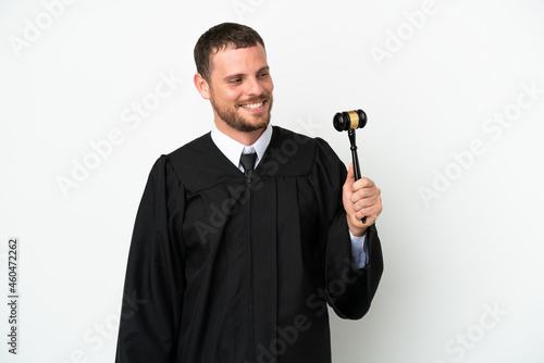 Judge caucasian man isolated on white background looking to the side and smiling