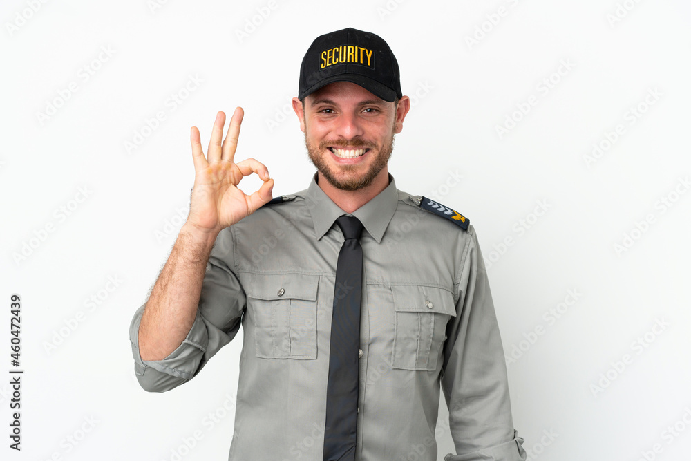 Young security Brazilian man isolated on white background showing ok sign with fingers Young security Brazilian man isolated on white background showing ok sign with fingers