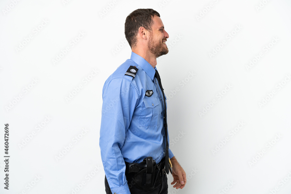 Fototapeta premium Young police Brazilian man isolated on white background laughing in lateral position