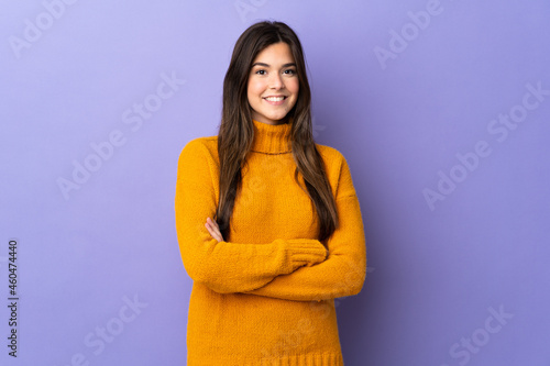 Teenager Brazilian girl over isolated purple background looking to the side © luismolinero
