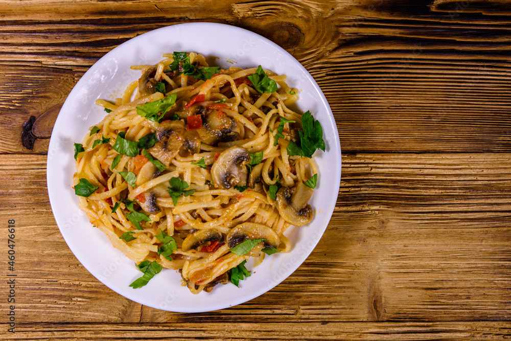 Pasta with mushrooms and tomato sauce in a plate. Top view Pasta with mushrooms and tomato sauce in a plate. Top view