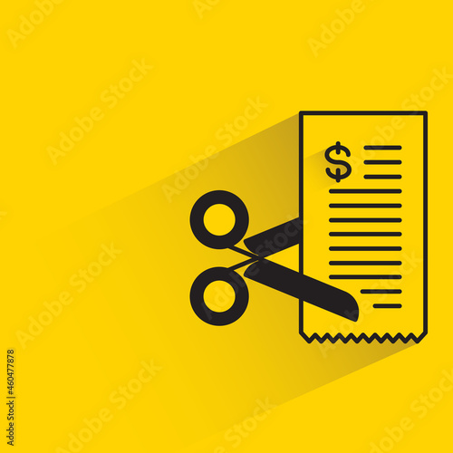 cutting bill with scissors on yellow background