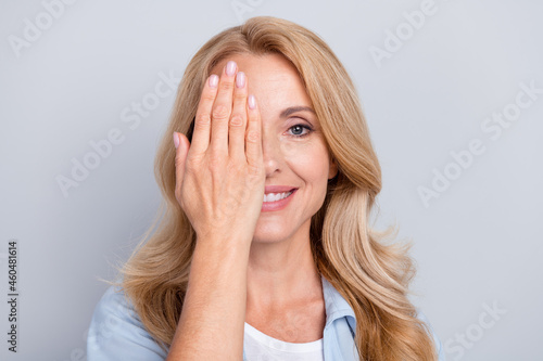 Portrait of young smiling good mood female cover close half face eyesight vision isolated on grey color background