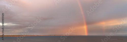 Rainbow over large Volga river large panoramic view