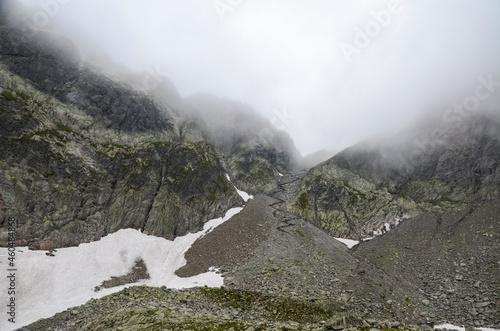 Scenic view of cloudy rainy rocky High Tatras mountains covered in fog. Natural landscape in Slovakia