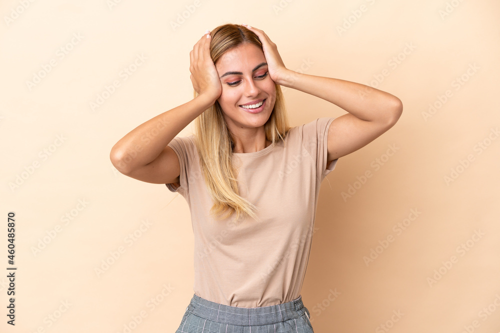 Blonde Uruguayan girl isolated on beige background laughing Blonde Uruguayan girl isolated on beige background laughing