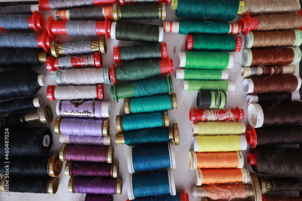 Rows of colorful sewing thread spools Rows of colorful sewing thread spools