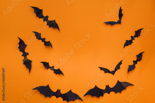 Halloween background. Bats on an orange background. Flat lay, copy space