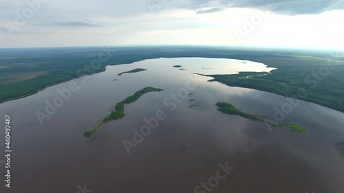 Big Taiga Lake.	Filming from a drone taking off over the lake. The lake is located among forests and swamps. On the island's lake