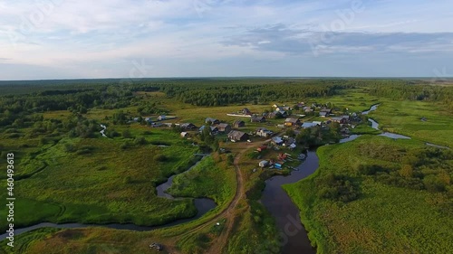 Flight over Village.	The camera flies on a small river towards the village. The village is also small, there is a forest behind the village