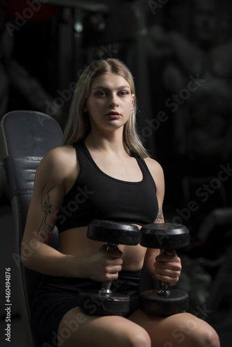 Portrait of a blonde beautiful sportswoman in the fitness room.