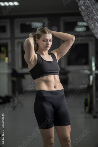 Portrait of a blonde beautiful sportswoman in the fitness room.