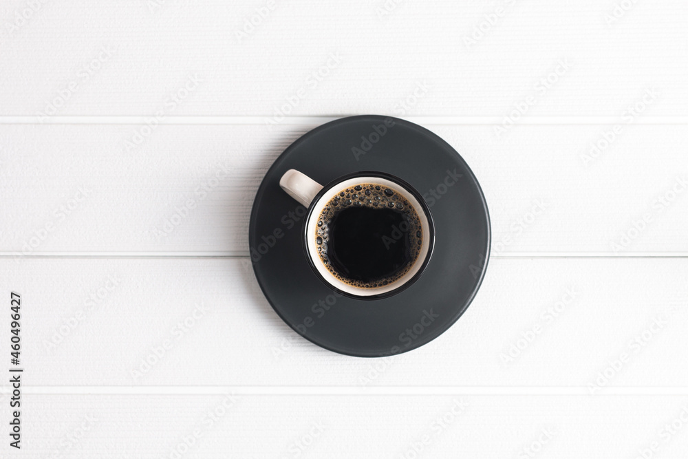 Top view black coffee with some foam isolated on a white wooden table