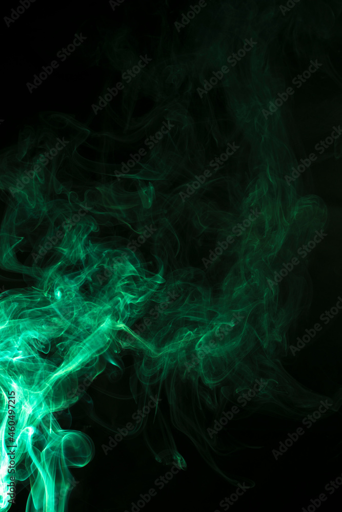 The movement of green smoke takes place on a fierce black background, fearing an abstraction on a black background. The movement of green smoke takes place on a fierce black background, fearing an abstraction on a black background.