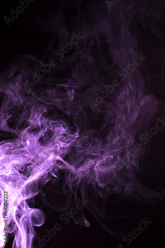 The movement of pink smoke takes place on a fierce black background, fearing an abstraction on a black background.