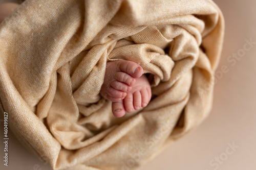 legs of a newborn baby on a beige background. baby feet © Svetlana